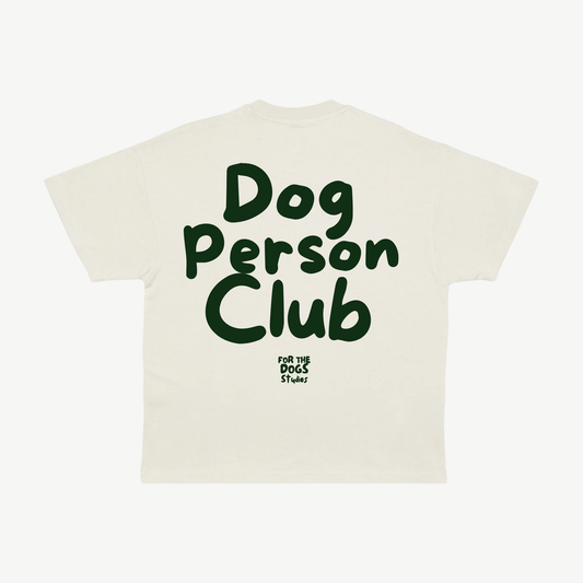 Back of a cream tee with large dark green Dog Person Club lettering and the For The Dogs Studios logo.