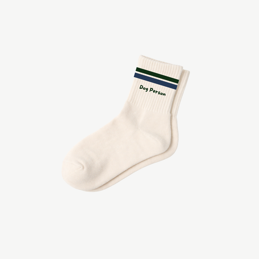 Cream ribbed Dog Person socks with green and navy stripes around the cuffs and small Dog Person lettering.