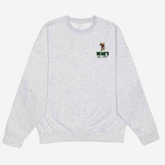 Front of a light grey crewneck with a small dog portrait and green Bear’s Fan Club chest print.