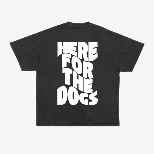 Back of a black tee with large white “Here for the Dogs” lettering stacked vertically.
