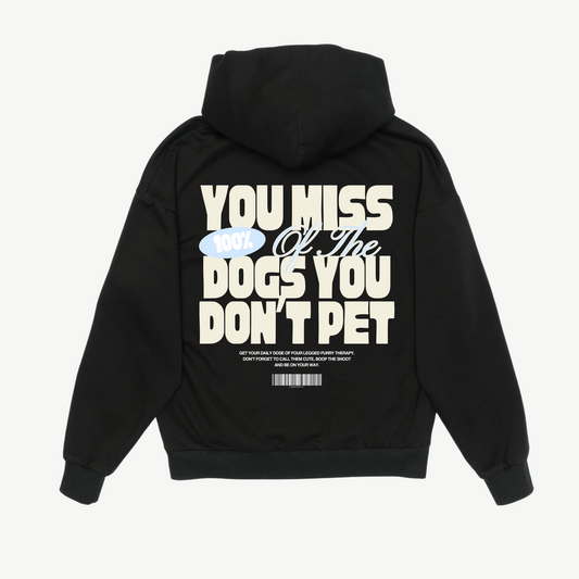 Back of a black hoodie with cream and pale blue “You miss 100% of the dogs you don’t pet” lettering.