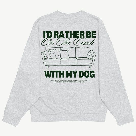 Back of a light grey crewneck with a green couch illustration and “I’d rather be on the couch with my dog” lettering.