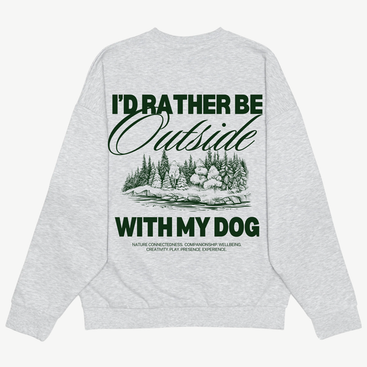 Back of a light grey crewneck with a green woodland illustration and “I’d rather be outside with my dog” lettering.