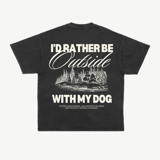 Back of a black tee with a cream woodland illustration and “I’d rather be outside with my dog” lettering.